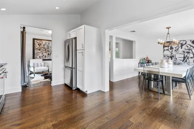 a view of kitchen with refrigerator stove and wooden floor