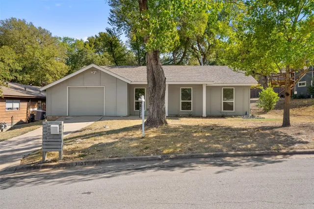a house that has a tree in front of it
