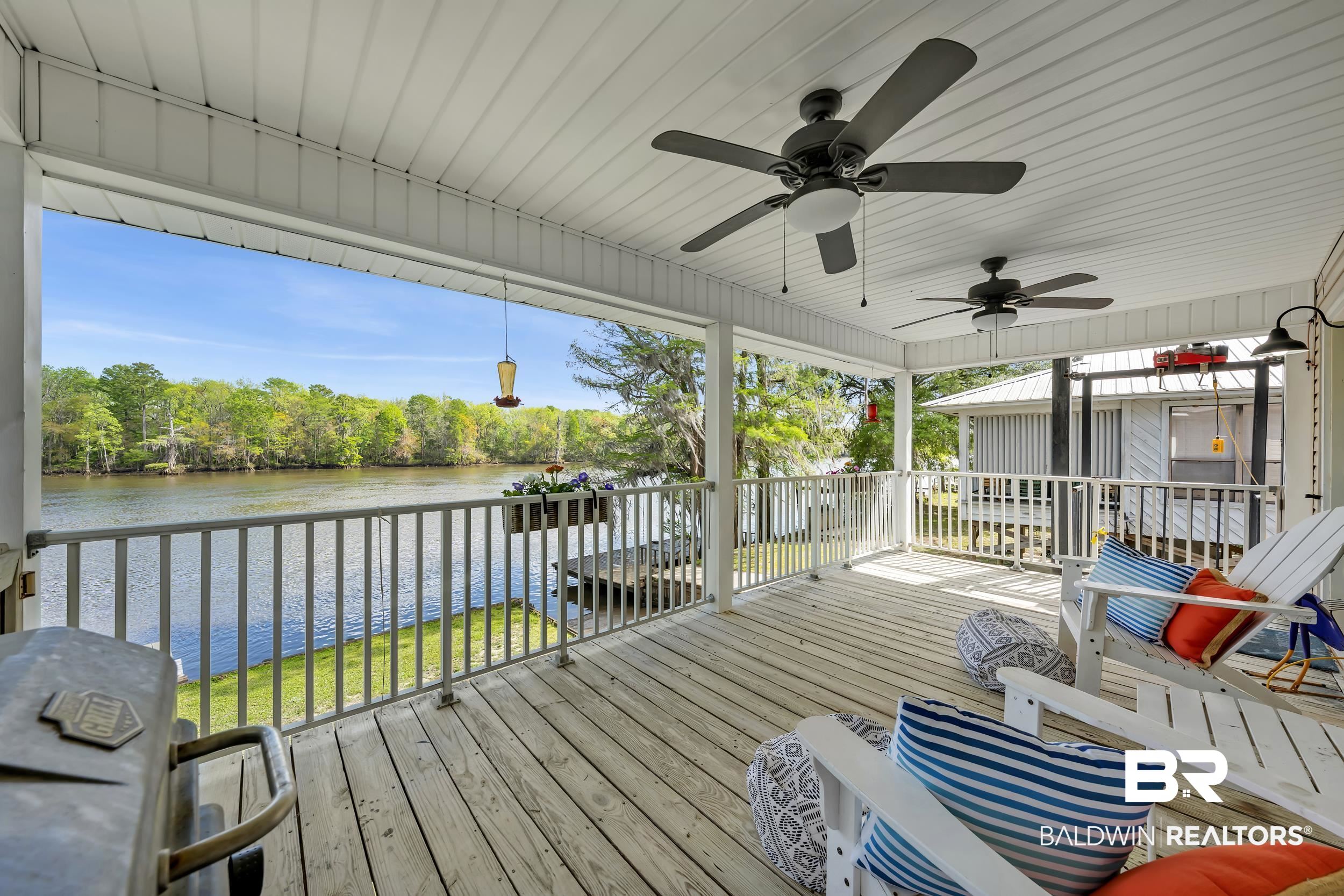 8081 Bryant's Lndg Road Stockton, AL 36579 - Photo 15 of 48 Deck with a water view, grilling area, a ceiling fan, and a sunroom