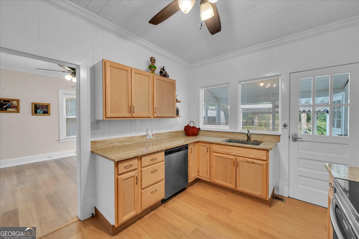 425 3rd Street Vienna, GA 31092 - Photo 11 of 40 a kitchen with a sink and cabinets