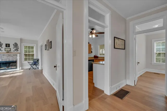 a view of a livingroom with wooden floor and a fireplace