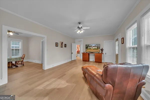 a living room with furniture and wooden floor
