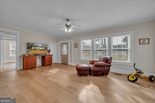 a living room with furniture and large windows
