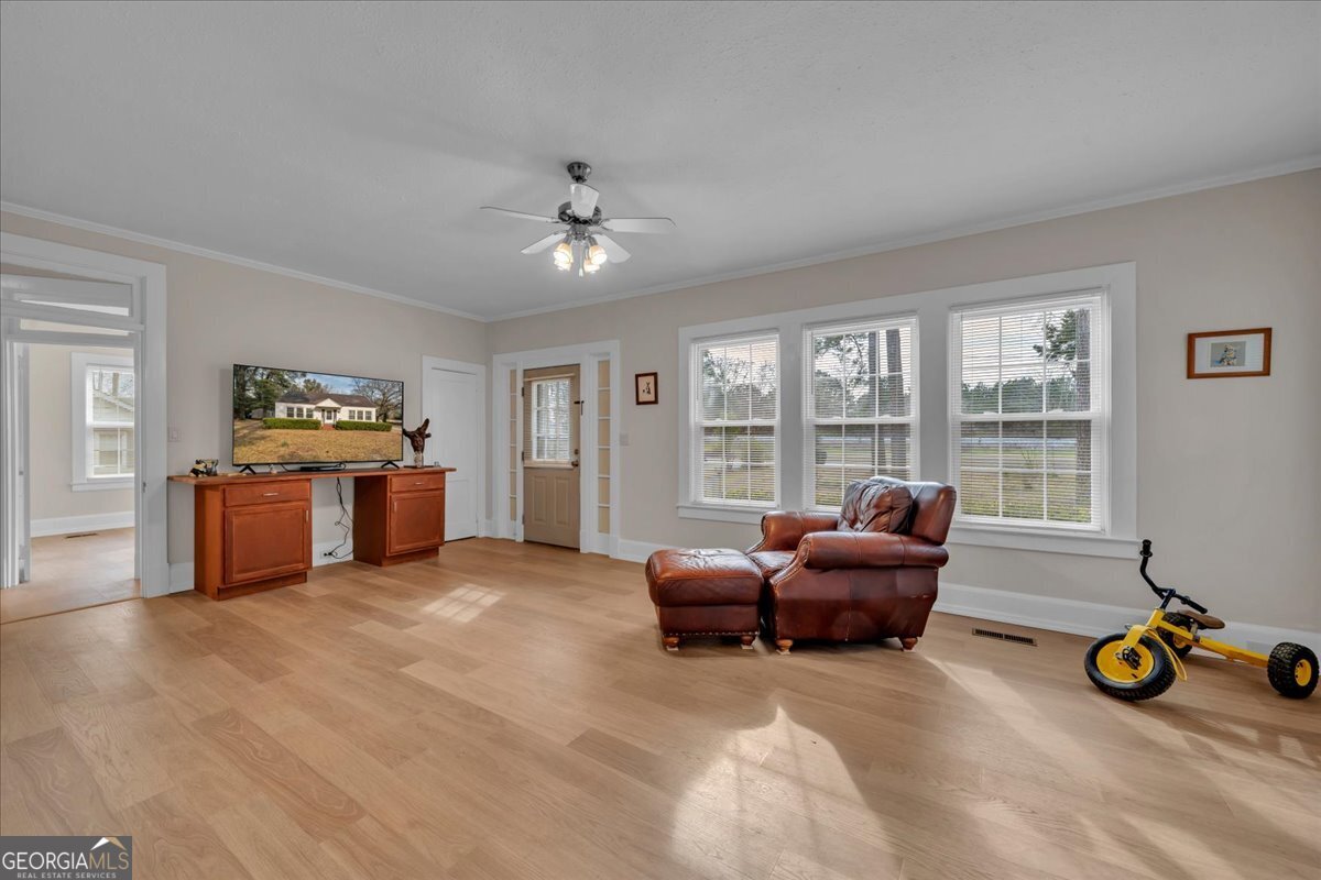 425 3rd Street Vienna, GA 31092 - Photo 5 of 40 a living room with furniture and large windows