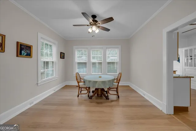 a dining room with furniture and window