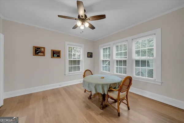 a view of a dining room with furniture window and wooden floor