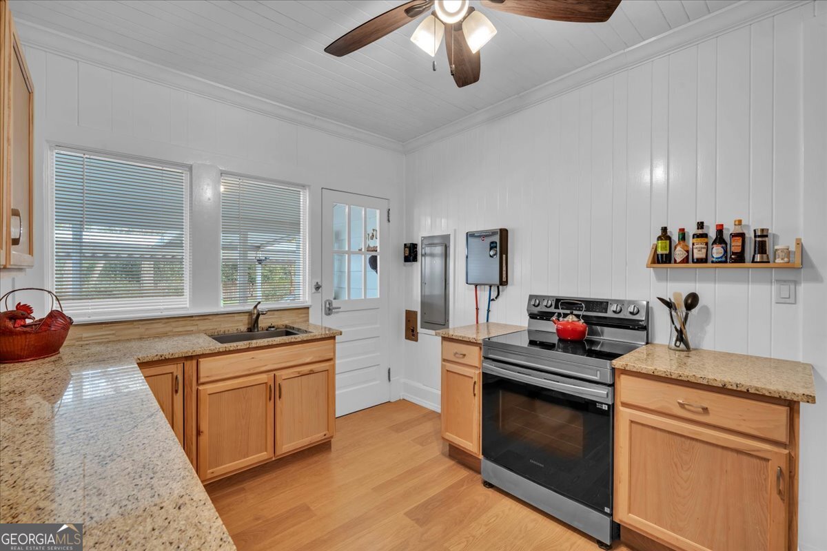 425 3rd Street Vienna, GA 31092 - Photo 10 of 40 a kitchen that has a lot of cabinets in it