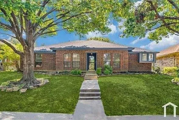 a front view of a house with yard patio and green space