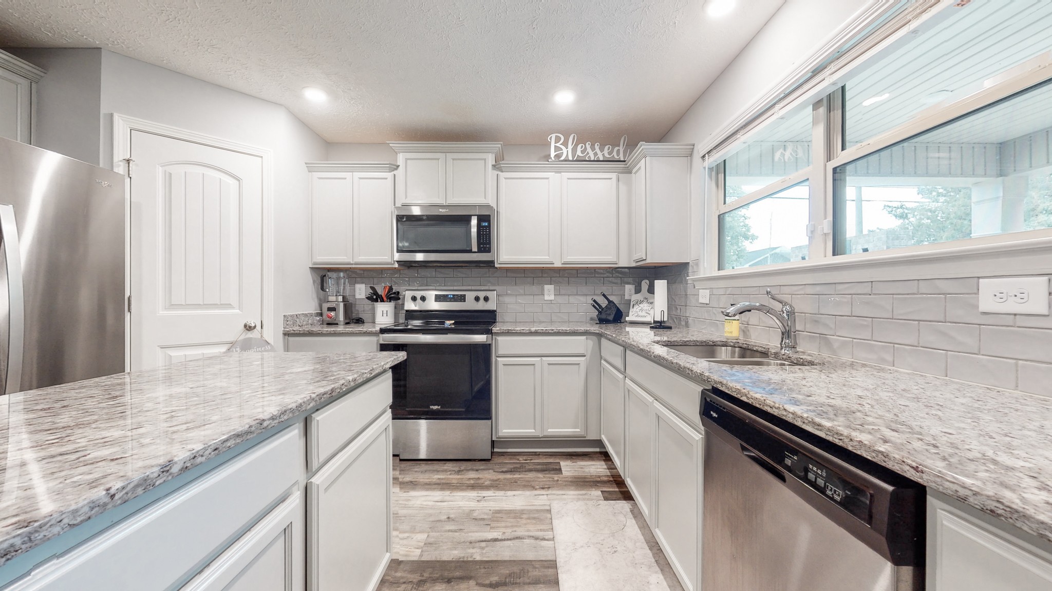 301 Homer Jackson Drive Smyrna, TN 37167 - Photo 6 of 27 a kitchen with kitchen island granite countertop a sink appliances cabinets and a counter top space