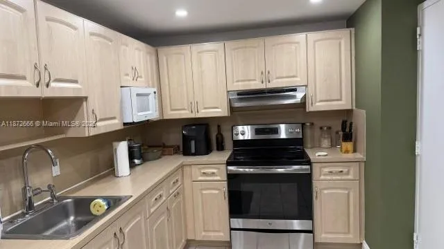 a kitchen with a sink and white cabinets