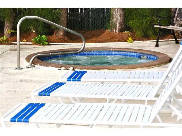 a view of swimming pool from a lounge chair