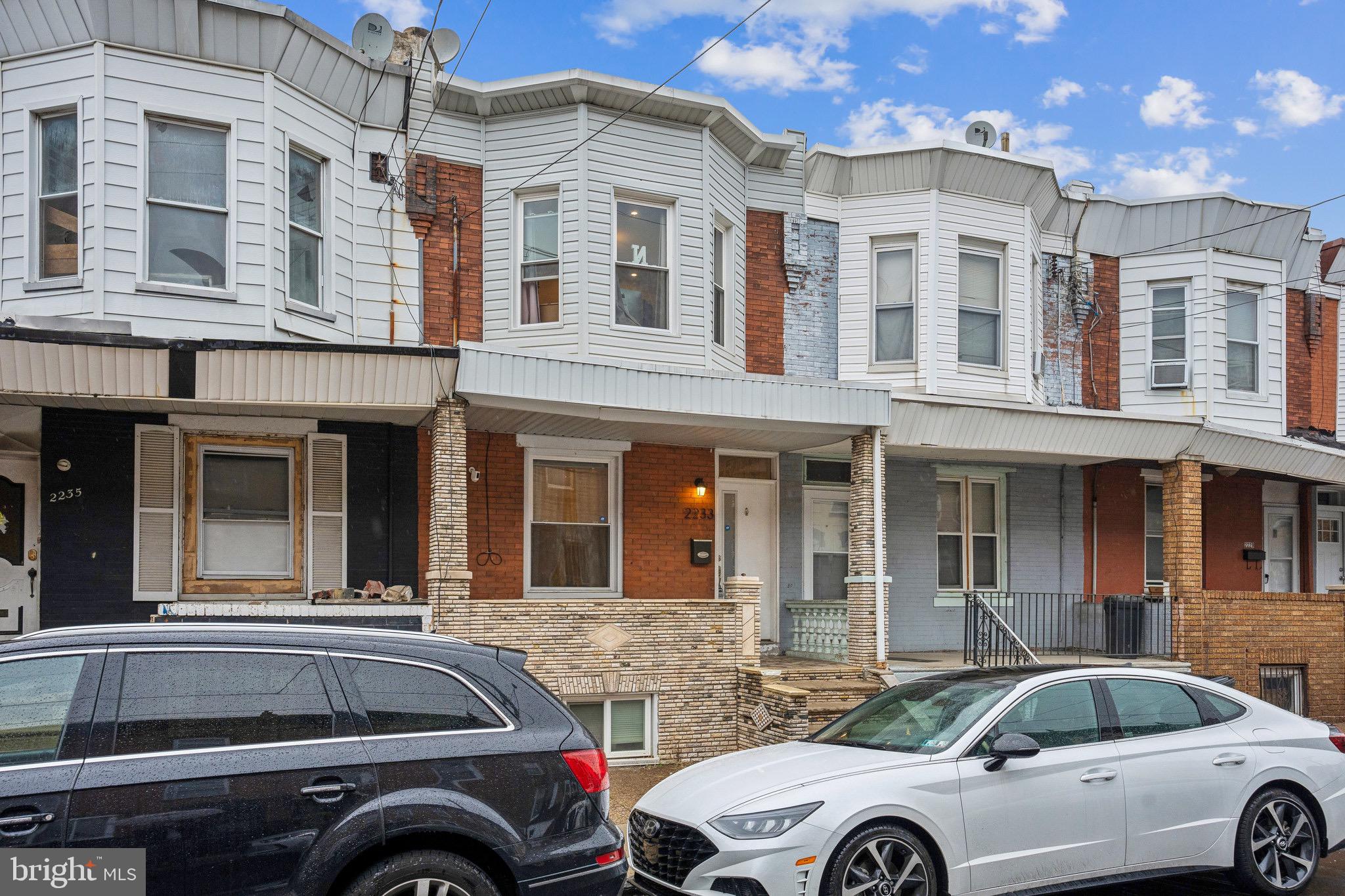 2233 Moore Street Philadelphia, PA 19145 - Photo 1 of 24 a front view of a house with parking space