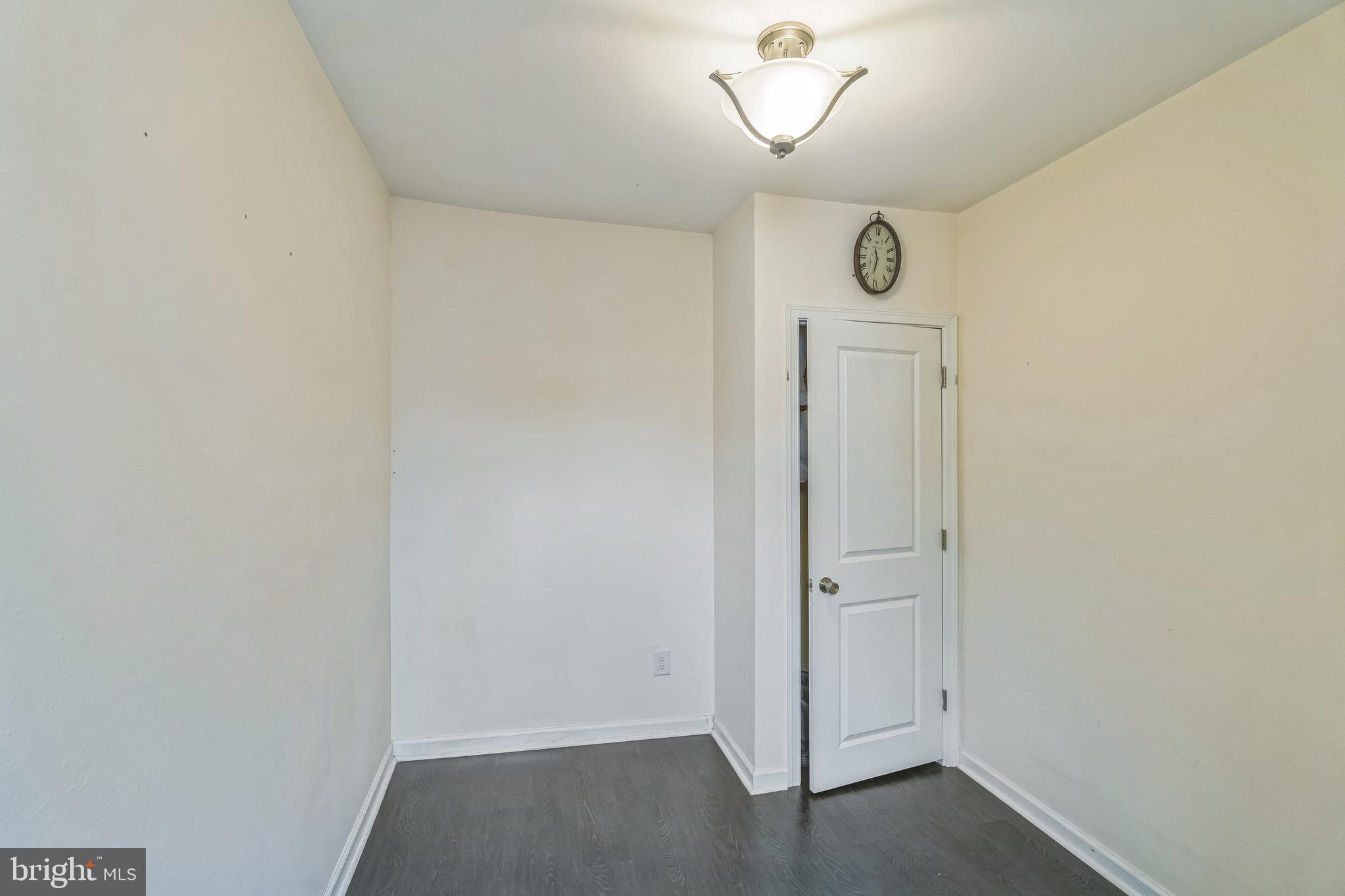2233 Moore Street Philadelphia, PA 19145 - Photo 13 of 24 an empty room with wooden floor and mirror