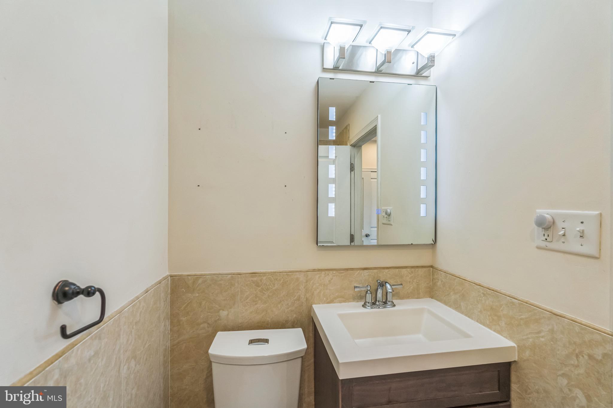 2233 Moore Street Philadelphia, PA 19145 - Photo 17 of 24 a bathroom with a sink vanity and mirror