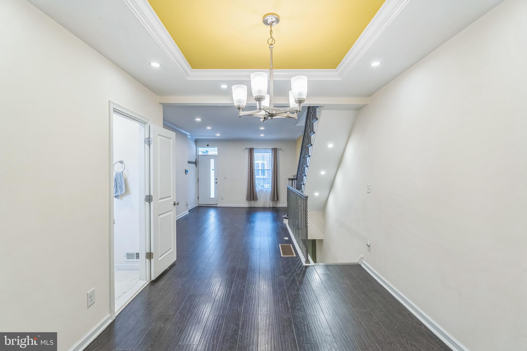 2233 Moore Street Philadelphia, PA 19145 - Photo 6 of 24 a view of a hallway with wooden floor and chandelier