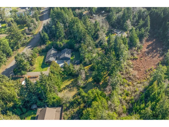 an aerial view of a house with a yard