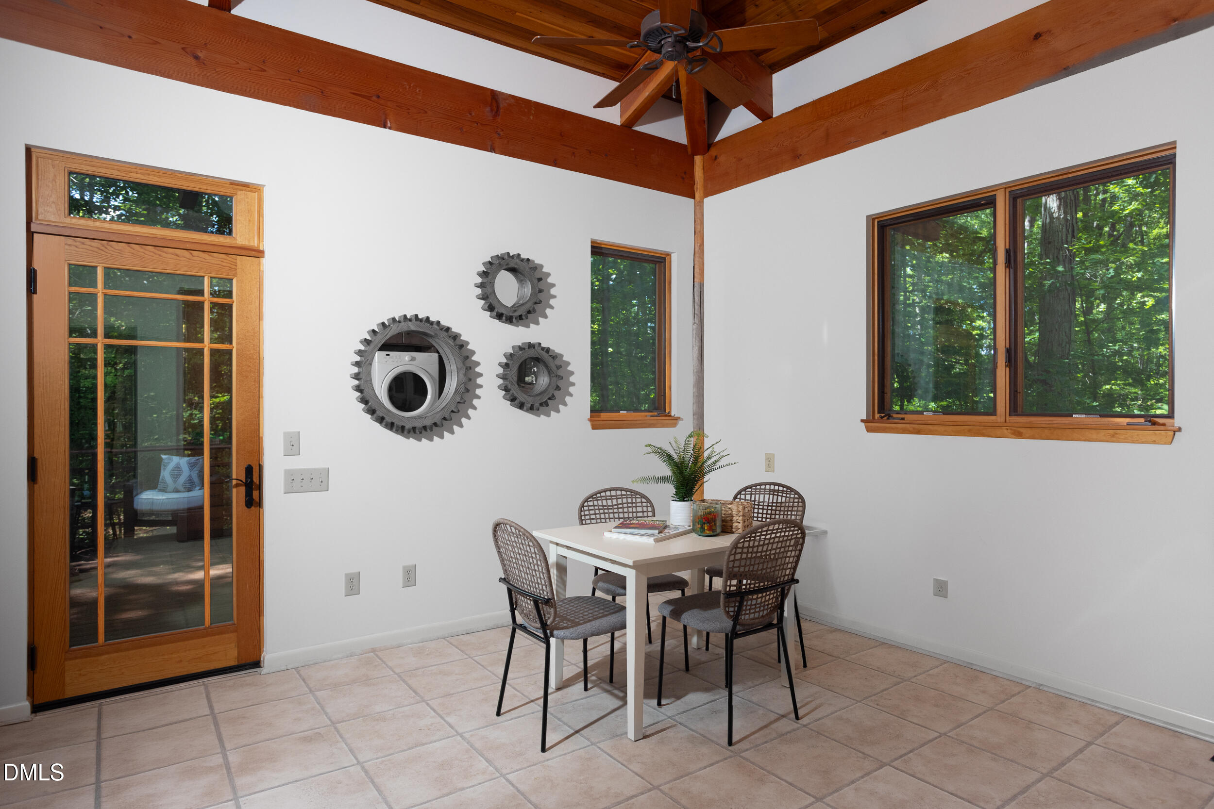 260 Bc Way Rougemont, NC 27572 - Photo 29 of 76 a dining room with wooden floor a glass table and chairs