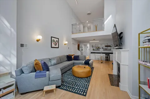 a living room with furniture and a chandelier