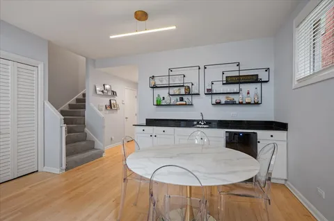a room with a table chairs and wooden floor