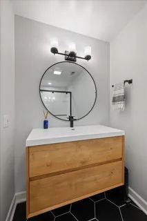 a bathroom with a sink and mirror