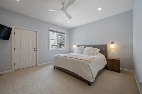 a spacious bedroom with a bed and a window