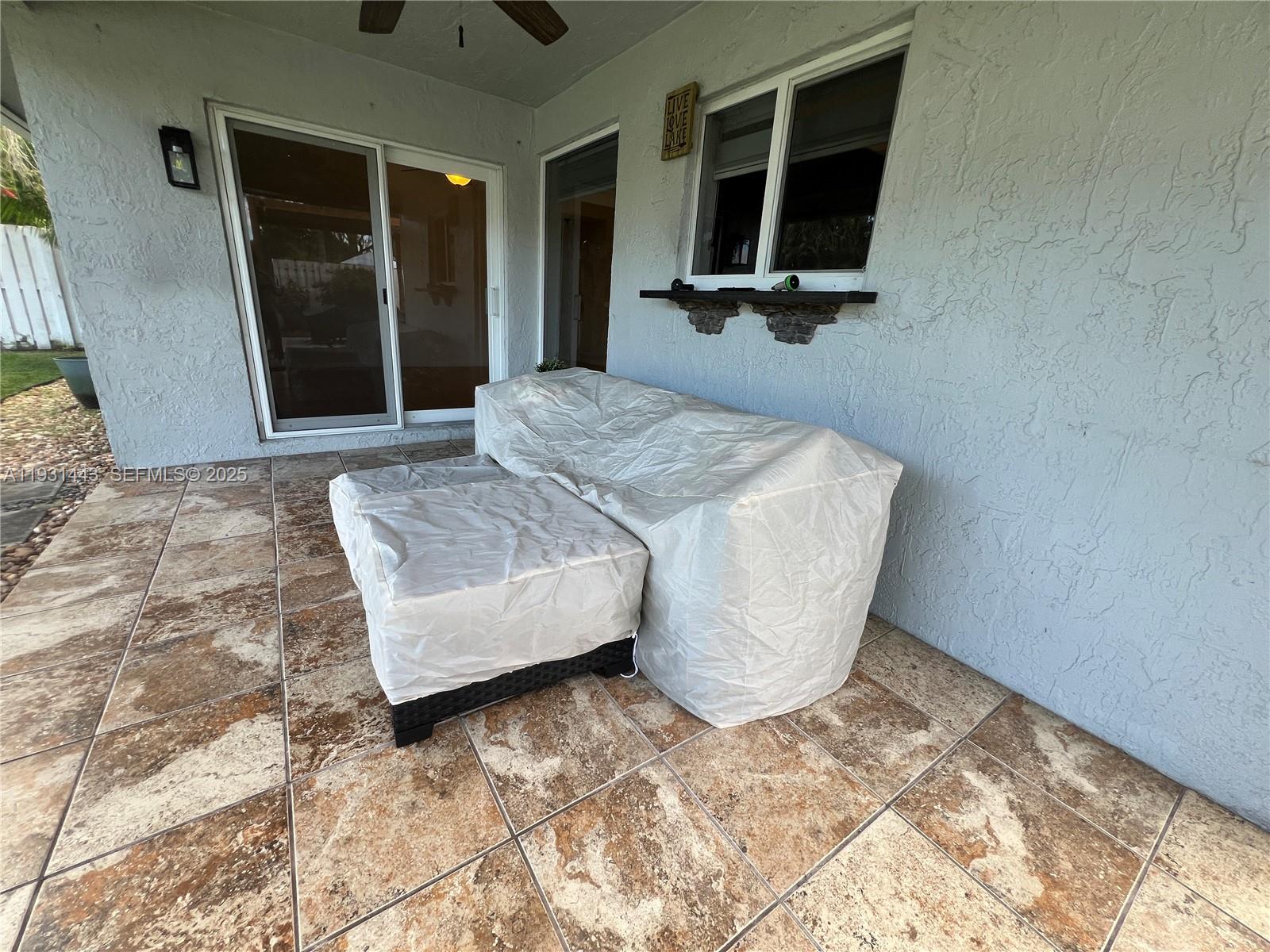 13721 Newport Manor Davie, FL 33325 - Photo 11 of 16 a bedroom with a bed and a window