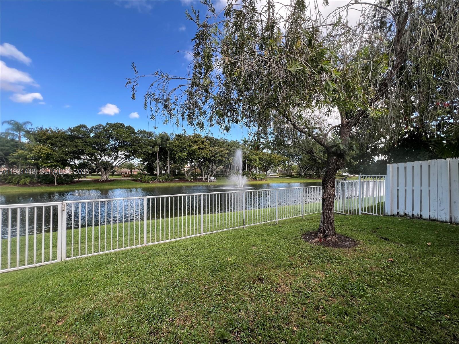 13721 Newport Manor Davie, FL 33325 - Photo 12 of 16 a view of a yard with a fence