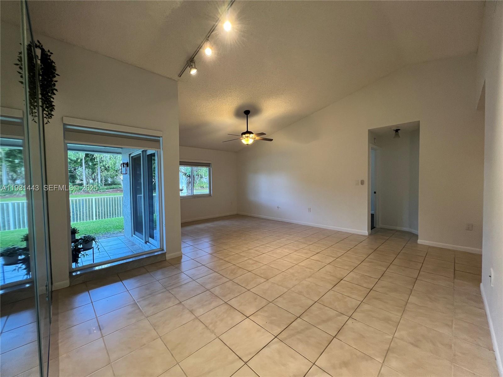 13721 Newport Manor Davie, FL 33325 - Photo 7 of 16 an empty room with windows and entrance