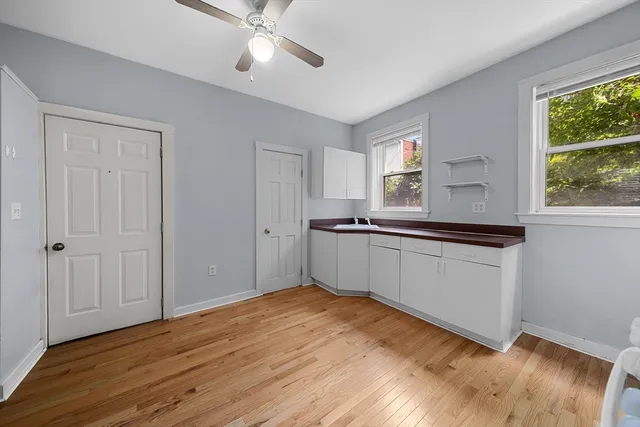 a kitchen with granite countertop white cabinets and white appliances