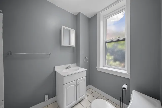a bathroom with a toilet sink and vanity