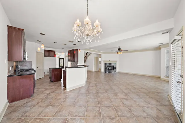 a kitchen with stainless steel appliances granite countertop a sink and a refrigerator