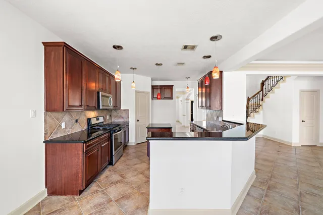 a kitchen that has a cabinets and a stove