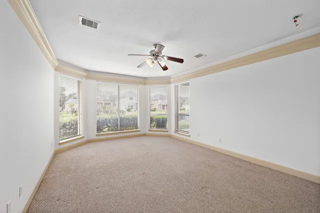 a spacious bathroom with a granite countertop sink a mirror and a shower