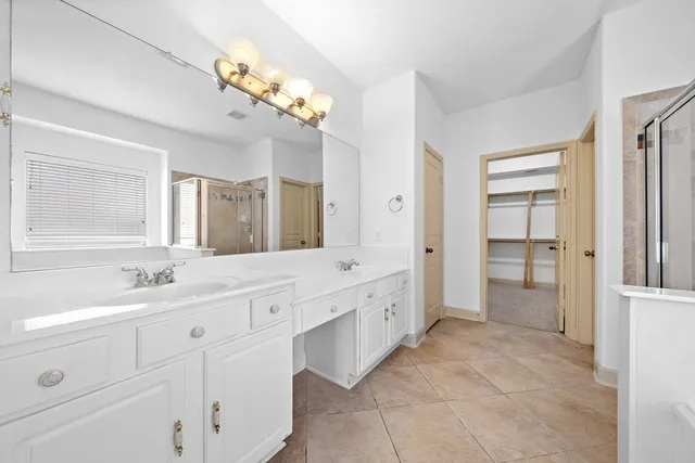 a bathroom with a double vanity sink and a mirror