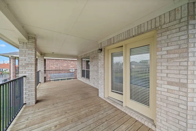 a view of a patio with a table and chairs under an umbrella