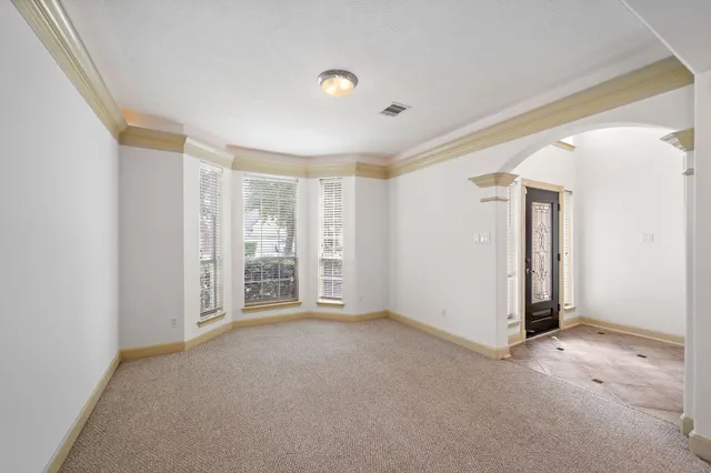 a view of a livingroom with wooden floor and white walls