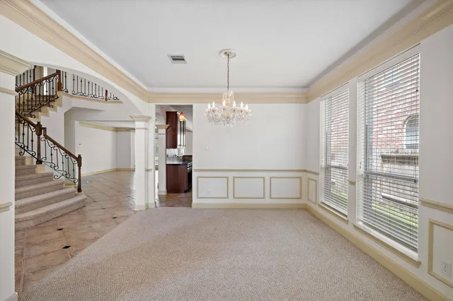 a view of a room with window and chandelier
