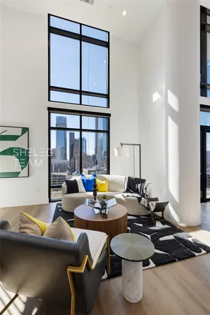 a living room with furniture a window and a table