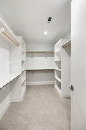 a view of walk in closet with empty racks