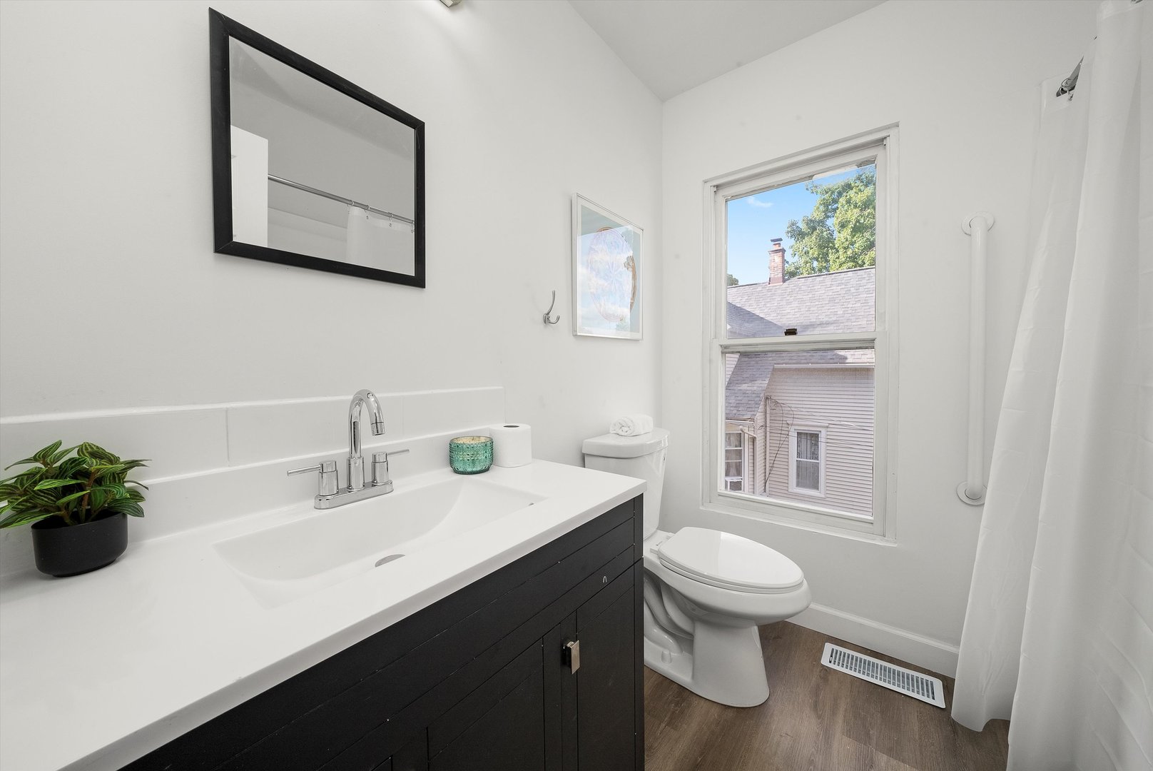 628 South Liberty Street Elgin, IL 60120 - Photo 11 of 22 a bathroom with a toilet a sink and mirror