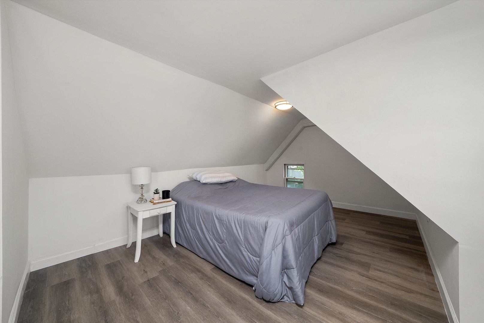 628 South Liberty Street Elgin, IL 60120 - Photo 13 of 22 a bedroom with a bed and a lamp on table