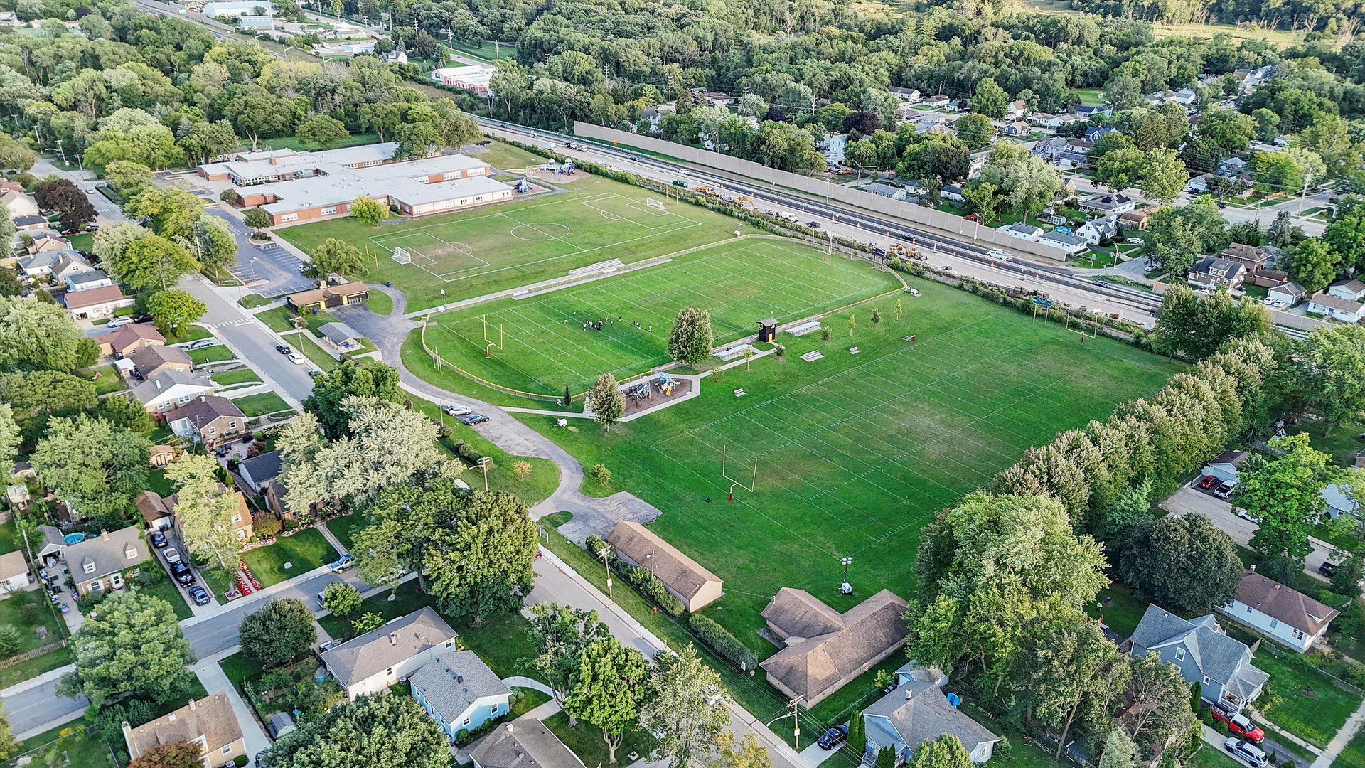 628 South Liberty Street Elgin, IL 60120 - Photo 20 of 22 an aerial view of a residential houses with a garden and lake