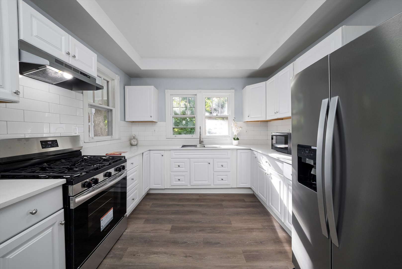 628 South Liberty Street Elgin, IL 60120 - Photo 2 of 22 a kitchen with granite countertop a refrigerator stove top oven and sink