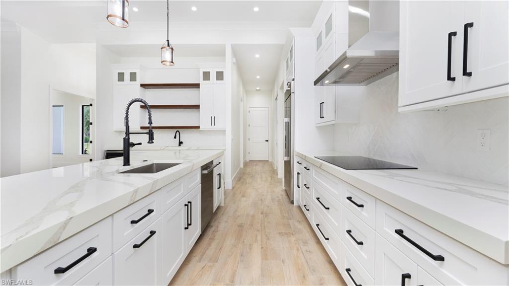 652 15th Street Southwest Naples, FL 34117 - Photo 12 of 47 a large kitchen with a lot of counter space and wooden floor