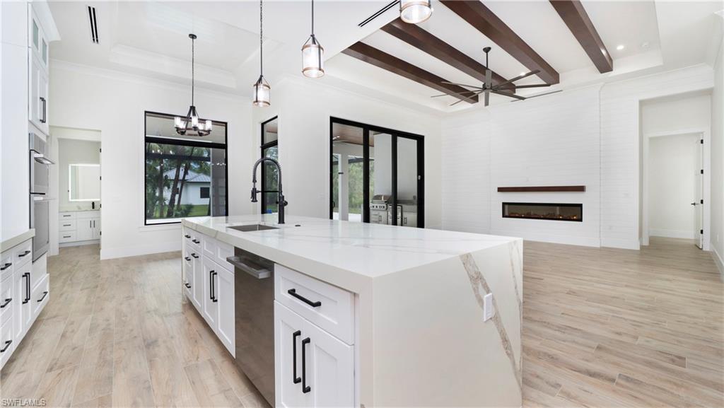 652 15th Street Southwest Naples, FL 34117 - Photo 47 of 47 a kitchen with a stove and a wooden floors