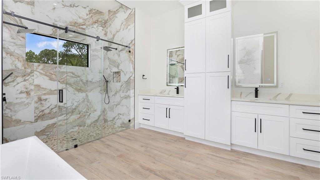 652 15th Street Southwest Naples, FL 34117 - Photo 27 of 47 a bathroom with a double vanity sink a toilet and shower