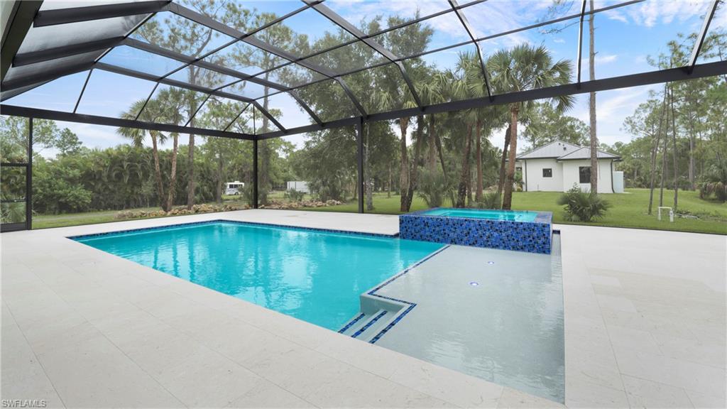 652 15th Street Southwest Naples, FL 34117 - Photo 31 of 47 a view of a swimming pool with a patio