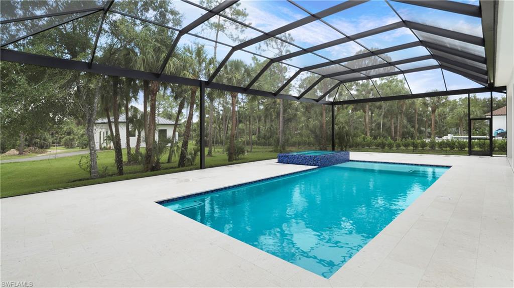 652 15th Street Southwest Naples, FL 34117 - Photo 33 of 47 a view of a swimming pool with a patio