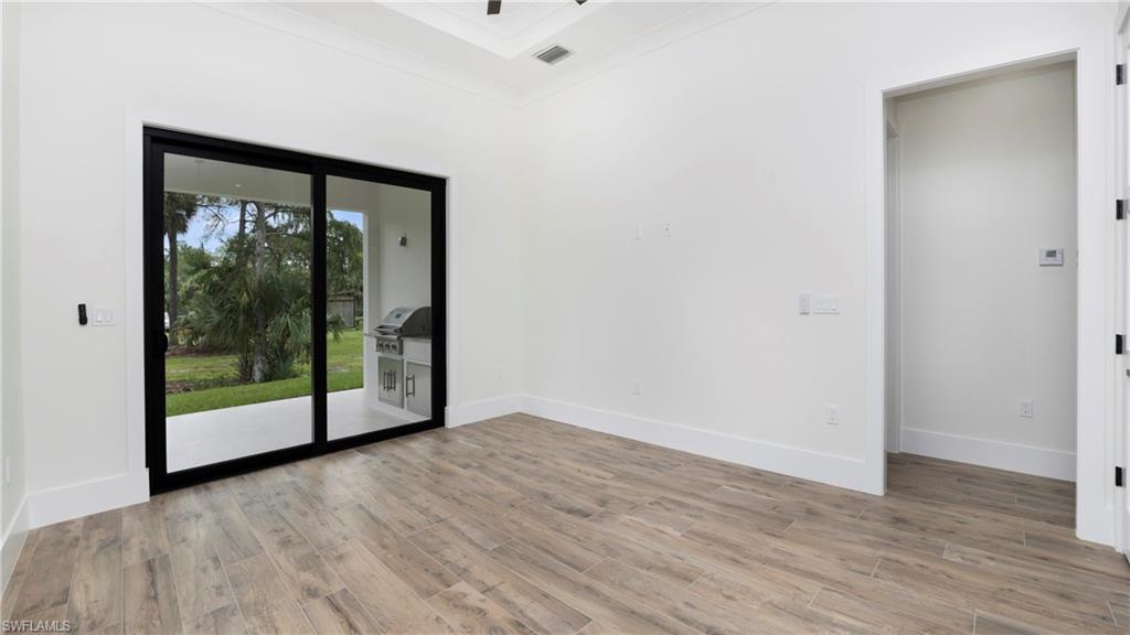 652 15th Street Southwest Naples, FL 34117 - Photo 37 of 47 a view of an empty room with wooden floor and a window