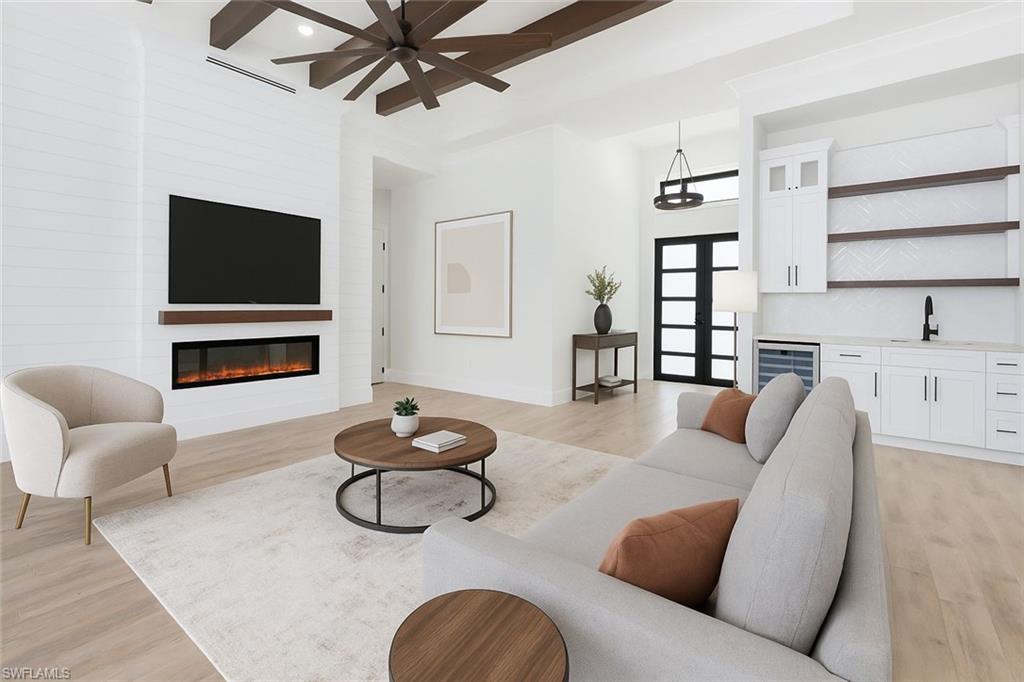 652 15th Street Southwest Naples, FL 34117 - Photo 4 of 47 a living room with furniture and a flat screen tv